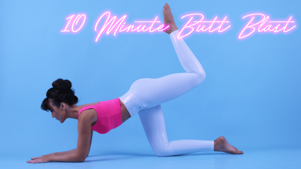 Lisa, dressed in pink sportswear, demonstrates a Pilates exercise in a studio setting.