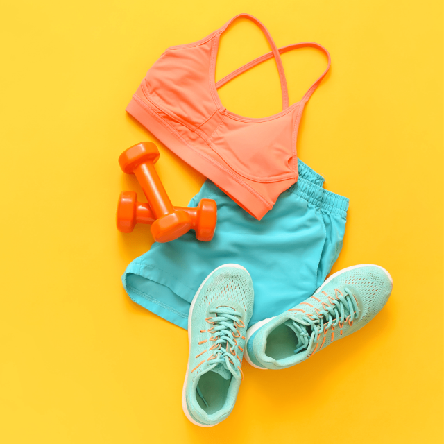 Lisa demonstrates a Pilates exercise with dumbbells, wearing sporty attire in a vibrant setting.