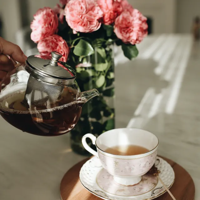 A serene tea set including a teapot, cups, and saucers arranged for post-Pilates relaxation in the Pilates by Lisa studio.